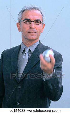 Businessman with silver ball View Large Photo Image Stock Image - Businessman with silver ball. Fotosearch