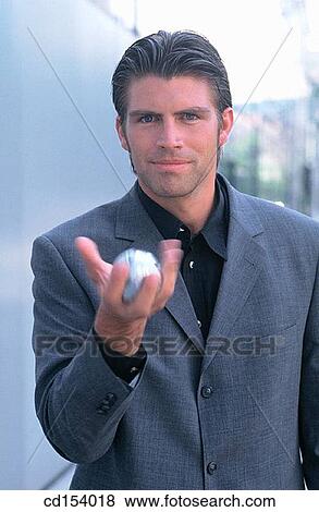 Businessman with silver ball View Large Photo Image Stock Photo - Businessman with silver ball. Fotosearch