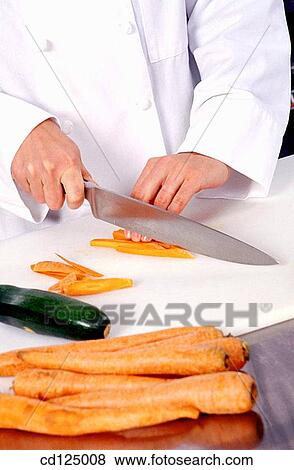 Chef cutting carrots View Large Photo Image Stock Photo - Chef cutting carrots. Fotosearch