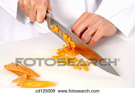 Chef cutting carrots View Large Photo Image Stock Photo - Chef cutting carrots. Fotosearch
