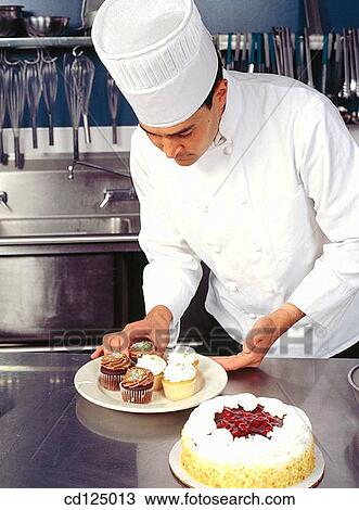 Stock Image - Chef with cakes. Fotosearch