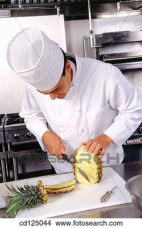 Cheff cutting pineapple View Large Photo Image Picture - Cheff cutting pineapple. Fotosearch