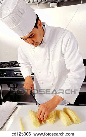 Cheff cutting pineapple View Large Photo Image Stock Photograph - Cheff cutting pineapple. Fotosearch
