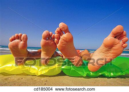 chilling out, air-bed, beach, barefoot, amusing, air mattress View Large Photo Image Picture - chilling out, air-bed, beach, barefoot, amusing, air mattress. Fotosearch