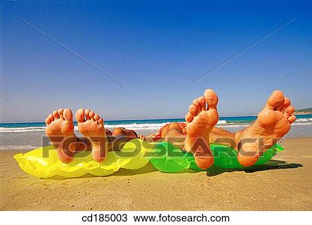 Stock Image - chilling out, air-bed, beach, barefoot, amusing, air mattress. Fotosearch