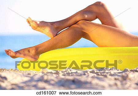 Stock Photo - chilling out, air-bed, Body part, body, beach, air mattress. Fotosearch
