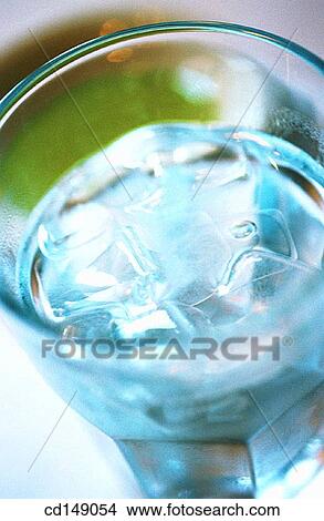 Close shot of ice cubes in a glass of water. View Large Photo Image Picture - Close shot of ice cubes in a glass of water.. Fotosearch