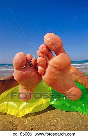 Stock Photography - Close-up, air-bed, beach, barefoot, amusing, air mattress. Fotosearch