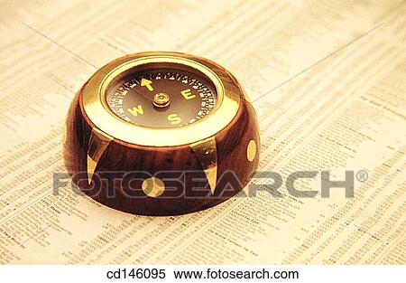 Stock Photography - Compass on stock report. Fotosearch