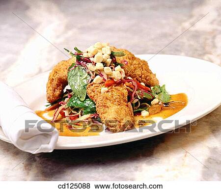 Stock Photo - Fried chicken topped with corn and green. Fotosearch