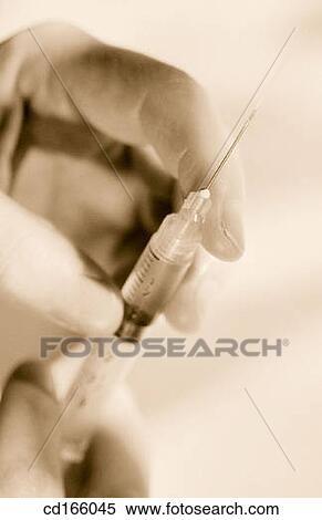 Hand and syringe View Large Photo Image Stock Photography - Hand and syringe. Fotosearch