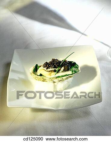 Poached oysters garnished with Osetra caviar View Large Photo Image Stock Image - Poached oysters garnished with Osetra caviar. Fotosearch