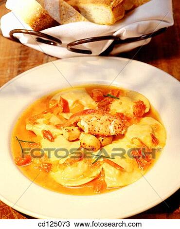 Stock Image - Raviolli with scallops and lobster. Fotosearch
