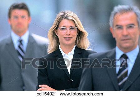 Stock Image - Three businesspeople looking at camera. Fotosearch