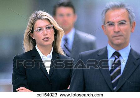 Three businesspeople looking at camera View Large Photo Image Stock Image - Three businesspeople looking at camera. Fotosearch
