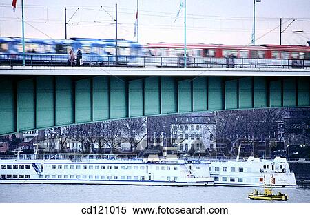 Trams crossing Deutzer Bridge (Deutzer Rheinbr? cke) at Rhine River. Cologne. Germany View Large Photo Image Stock Photography - Trams crossing Deutzer Bridge (Deutzer Rheinbr? cke) at Rhine River. Cologne. Germany. Fotosearch