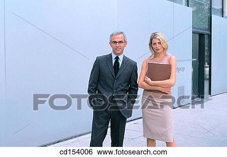 Two businesspeople looking at camera View Large Photo Image Stock Photograph - Two businesspeople looking at camera. Fotosearch