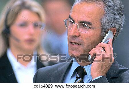 Stock Photo - Two executives talking on cell phones. Fotosearch