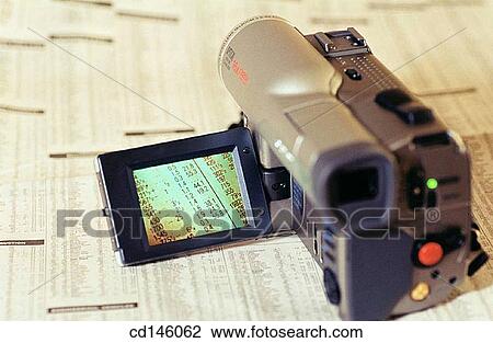 Video camera and stock report View Large Photo Image Stock Image - Video camera and stock report. Fotosearch