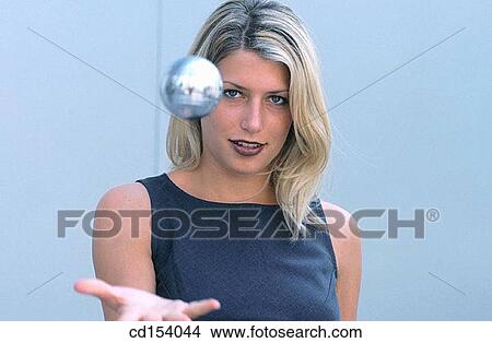 Woman throwing silver ball View Large Photo Image Picture - Woman throwing silver ball. Fotosearch