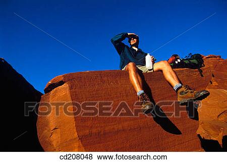 A backpacker takes a break View Large Photo Image Stock Photo - A backpacker takes a break. Fotosearch
