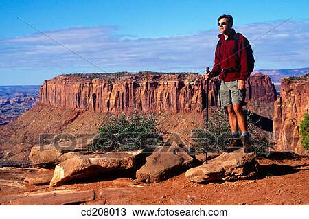 A man hiking in Cayonlands National Park, Utah, USA View Large Photo Image Stock Image - A man hiking in Cayonlands National Park, Utah, USA. Fotosearch