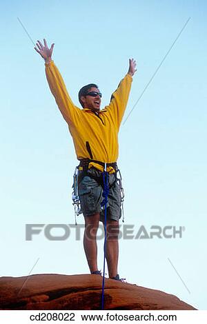 A rock climber reaches the top and celebrates View Large Photo Image Stock Image - A rock climber reaches the top and celebrates. Fotosearch