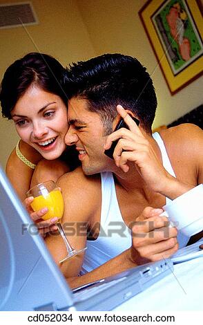 Picture - breakfast, cell phone, busy, brunette, at-home. Fotosearch