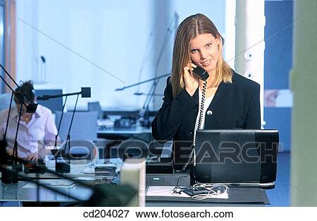 Businesswoman talking on phone, working with laptop View Large Photo Image Stock Photo - Businesswoman talking on phone, working with laptop. Fotosearch