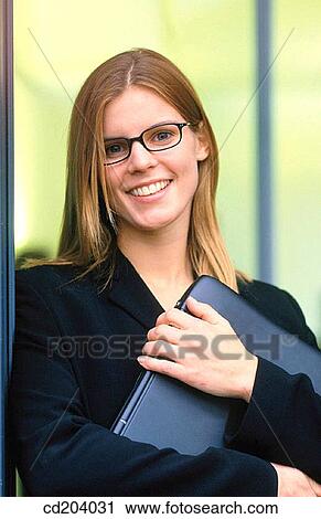 Businesswoman with files, looking at camera View Large Photo Image Stock Image - Businesswoman with files, looking at camera. Fotosearch