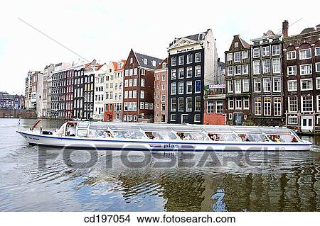 Picture - Canal tour boat at Damrak. Amsterdam. Holland. Fotosearch