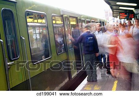Stock Image - Commuters alighting from train, Dublin. Fotosearch