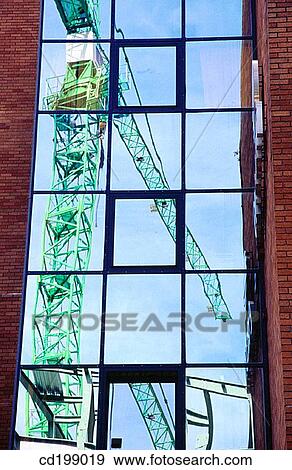Construction crane reflected in window View Large Photo Image Stock Photo - Construction crane reflected in window. Fotosearch