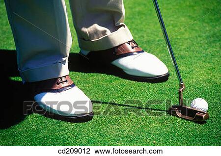 Stock Image - Detail of a golfer putting. Fotosearch