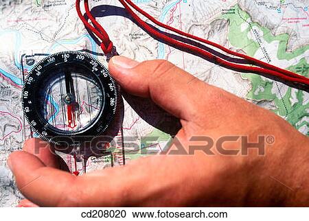 Detail of a hand using a compass on a map View Large Photo Image Stock Image - Detail of a hand using a compass on a map. Fotosearch