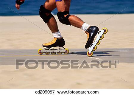 Detail of a man in-line skating at the beach View Large Photo Image Stock Photo - Detail of a man in-line skating at the beach. Fotosearch