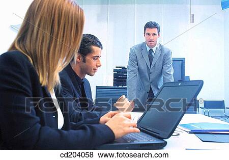 Executives in conference, businesswoman working on her laptop View Large Photo Image Stock Photo - Executives in conference, businesswoman working on her laptop. Fotosearch
