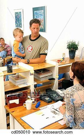 Father and son at the doctor's office View Large Photo Image Stock Image - Father and son at the doctor's office. Fotosearch