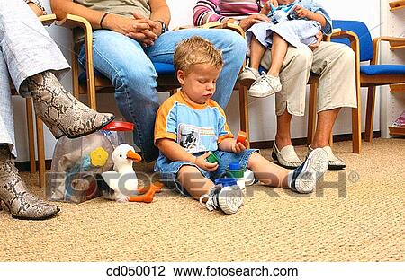 Stock Image - Father and son at the doctor's office. Fotosearch