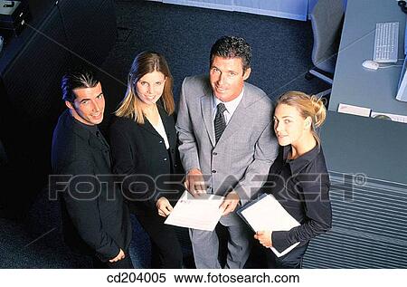 Four businesspeople with files looking at camera View Large Photo Image Stock Photography - Four businesspeople with files looking at camera. Fotosearch