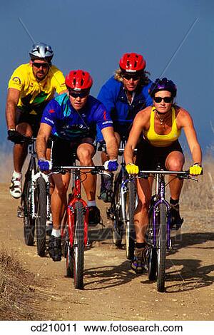 Four mountain bikers riding on a fire road View Large Photo Image Stock Image - Four mountain bikers riding on a fire road. Fotosearch