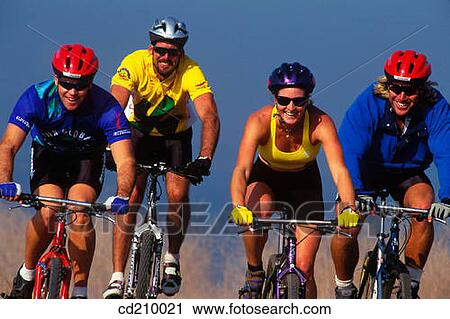 Four mountain bikers riding on a fire road View Large Photo Image Stock Image - Four mountain bikers riding on a fire road. Fotosearch
