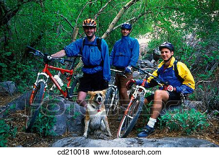 Group of mountain bikers and a dog take a break View Large Photo Image Stock Photo - Group of mountain bikers and a dog take a break. Fotosearch