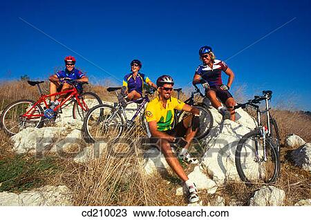 Group of mountain bikers taking a break View Large Photo Image Stock Image - Group of mountain bikers taking a break. Fotosearch