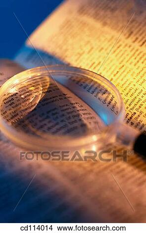 Magnifying glass on book View Large Photo Image Picture - Magnifying glass on book. Fotosearch