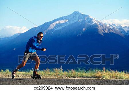 Man goes in-line skating on a mountain road View Large Photo Image Picture - Man goes in-line skating on a mountain road. Fotosearch