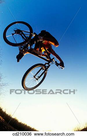 Man jumping on a mountain bike View Large Photo Image Stock Photograph - Man jumping on a mountain bike. Fotosearch