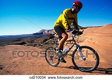 Man mountain biking near Moab, Utah, USA View Large Photo Image Picture - Man mountain biking near Moab, Utah, USA. Fotosearch