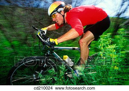 Picture - Man mountain biking. Fotosearch