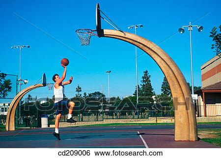 Man plays basketball on a neighborhood court View Large Photo Image Stock Photograph - Man plays basketball on a neighborhood court. Fotosearch